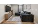 Stylish living room with a dark plush sectional, modern entertainment center, and patterned rug at 14096 Red Cosmos St, Parker, CO 80134