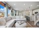 Bright, open-concept home with views of the kitchen, living and dining areas, and staircase at 14096 Red Cosmos St, Parker, CO 80134