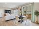 Open concept living and dining area with a view of the backyard through sliding glass doors at 14096 Red Cosmos St, Parker, CO 80134