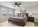 Serene main bedroom with a large bed, stylish ceiling fan, and picturesque window views at 14096 Red Cosmos St, Parker, CO 80134