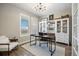 Inviting home office featuring neutral walls, wood floors, white bookcase and ample natural light at 14096 Red Cosmos St, Parker, CO 80134
