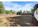 Large, sunny backyard with a wood fence, ready for landscaping and outdoor activities at 3980 S Hazel Ct, Englewood, CO 80110