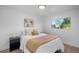 Bright bedroom features a comfortable bed, modern lighting, and a serene window view at 3980 S Hazel Ct, Englewood, CO 80110