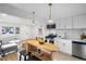 Cozy living room with a view into the modern kitchen, featuring a butcher block island at 3980 S Hazel Ct, Englewood, CO 80110