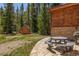 Backyard with a picnic table on the patio, shed, and trees, perfect for outdoor living at 5724 Highway 9, Breckenridge, CO 80424