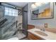Modern bathroom with a glass block window in the shower and a wood framed mirror at 5724 Highway 9, Breckenridge, CO 80424