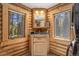 Bathroom with wood paneling, two windows, and forest views at 5724 Highway 9, Breckenridge, CO 80424