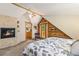 Cozy bedroom featuring a stone fireplace, balcony, and access to an ensuite bathroom at 5724 Highway 9, Breckenridge, CO 80424