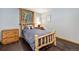 Charming bedroom with a rustic wooden bed frame and a view of the woods at 5724 Highway 9, Breckenridge, CO 80424