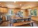 Bright dining area adjacent to kitchen, featuring wood table, chairs, bench, and stainless steel appliances at 5724 Highway 9, Breckenridge, CO 80424