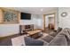 Comfortable living room with a large couch, media center, and rustic wood trim at 5724 Highway 9, Breckenridge, CO 80424