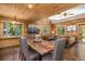 Warm and inviting living area with log walls, comfortable seating, and a view into the dining space at 5724 Highway 9, Breckenridge, CO 80424