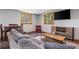 Open concept living room with gray couch, wood table, windows and natural light at 5724 Highway 9, Breckenridge, CO 80424