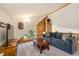 Comfortable living room with couch, TV, and views of nature from the windows at 5724 Highway 9, Breckenridge, CO 80424