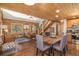 Open living area with log walls, hardwood floors, staircase, and seamless flow into the dining and kitchen area at 5724 Highway 9, Breckenridge, CO 80424