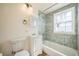 Compact bathroom showcasing tiled shower/bathtub, white vanity, and a mirrored medicine cabinet at 2858 Jasmine St, Denver, CO 80207