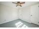 A bedroom featuring two closet doors, a ceiling fan and gray flooring at 2858 Jasmine St, Denver, CO 80207
