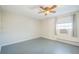 Bedroom featuring hardwood floors, neutral walls, and window with an air conditioner at 2858 Jasmine St, Denver, CO 80207