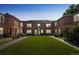 Exterior shot of a red brick apartment building with a spacious lawn and sidewalk in front at 2858 Jasmine St, Denver, CO 80207