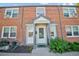 Charming brick townhouse featuring front door with sidelights and a covered entryway, perfect for curb appeal at 2858 Jasmine St, Denver, CO 80207