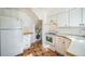 Efficient kitchen layout featuring white cabinets, modern appliances, and tile flooring, optimized for functionality at 2858 Jasmine St, Denver, CO 80207