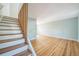 Open floor plan connecting a wooden staircase to the living room featuring light blue walls at 2858 Jasmine St, Denver, CO 80207