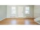 Hardwood floored living room featuring natural light, white door, and light paint; a spacious and inviting living area at 2858 Jasmine St, Denver, CO 80207