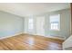 Inviting living room with hardwood floors, light walls and two windows flanking the door, creating a warm atmosphere at 2858 Jasmine St, Denver, CO 80207