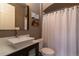 Stylish bathroom featuring a modern vessel sink, a mirror, and a shower with a white curtain at 1735 N Ogden St # 106, Denver, CO 80218