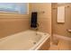 Bathroom with soaking tub, shower, and towel rack at 1735 N Ogden St # 106, Denver, CO 80218