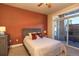 Cozy bedroom with rust colored accent wall, queen bed, and access to outdoor patio at 1735 N Ogden St # 106, Denver, CO 80218