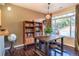 Cozy dining area with a wooden table, stool seating, and ample natural light from the large window at 1735 N Ogden St # 106, Denver, CO 80218
