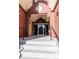 Exterior entrance featuring brick archway, steps leading up to the glass doors, and wrought iron railings at 1735 N Ogden St # 106, Denver, CO 80218