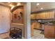 View of the kitchen with wooden cabinets, stone countertops and stainless steel appliances at 1735 N Ogden St # 106, Denver, CO 80218