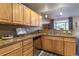 Kitchen features wooden cabinets, stone countertops, double sink and open concept design at 1735 N Ogden St # 106, Denver, CO 80218