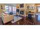 This living room showcases a fireplace, a built-in bar, hardwood floors, and cozy seating at 1735 N Ogden St # 106, Denver, CO 80218