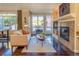 Bright living room featuring hardwood floors, a fireplace, and large windows that provide ample natural light at 1735 N Ogden St # 106, Denver, CO 80218
