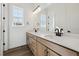 Bathroom showcasing a double sink vanity with modern black hardware and a large mirror at 8616 Pennycress Dr, Littleton, CO 80125