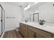 Modern bathroom featuring a double sink vanity, a glass enclosed shower, and modern fixtures at 8616 Pennycress Dr, Littleton, CO 80125