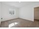 Neutral bedroom featuring neutral carpet, a single window, and closet at 8616 Pennycress Dr, Littleton, CO 80125