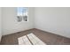 Carpeted bedroom with white walls and a large window provides natural light at 8616 Pennycress Dr, Littleton, CO 80125