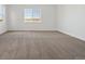 Bright, carpeted bedroom featuring natural light from a large window at 8616 Pennycress Dr, Littleton, CO 80125