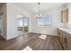 Bright dining area with hardwood floors, large windows, and sliding doors to the balcony with views at 8616 Pennycress Dr, Littleton, CO 80125