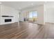 Bright living room featuring a modern fireplace and sliding glass doors to a balcony with views at 8616 Pennycress Dr, Littleton, CO 80125