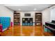 Basement area with wood laminate flooring, bookshelves, and connect four game at 3234 El Charro Pt, Castle Rock, CO 80108