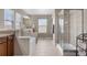 Bathroom with a soaking tub beneath large windows, and glass enclosed shower at 3234 El Charro Pt, Castle Rock, CO 80108