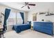 Bright bedroom with a ceiling fan, large window, and stylish blue accents and a dresser at 3234 El Charro Pt, Castle Rock, CO 80108