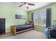 Cozy bedroom with natural wood bed frame, light green walls, and two windows at 3234 El Charro Pt, Castle Rock, CO 80108