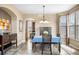 Formal dining room with tile flooring, a large window, and an elegant chandelier above the dining table at 3234 El Charro Pt, Castle Rock, CO 80108