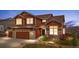 Charming two-story home with a two-car garage, manicured landscaping, and a warm, inviting facade at 3234 El Charro Pt, Castle Rock, CO 80108